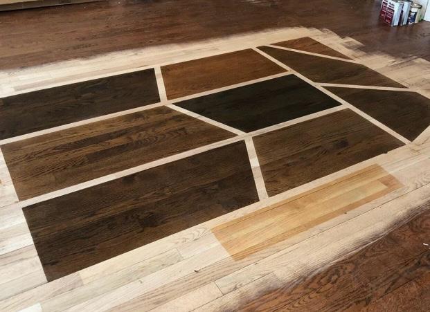 Custom hardwood stain samples prepared on a real floor